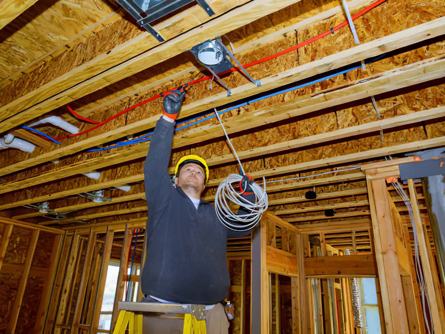 Rough-in wiring run through the wood framing of a new house